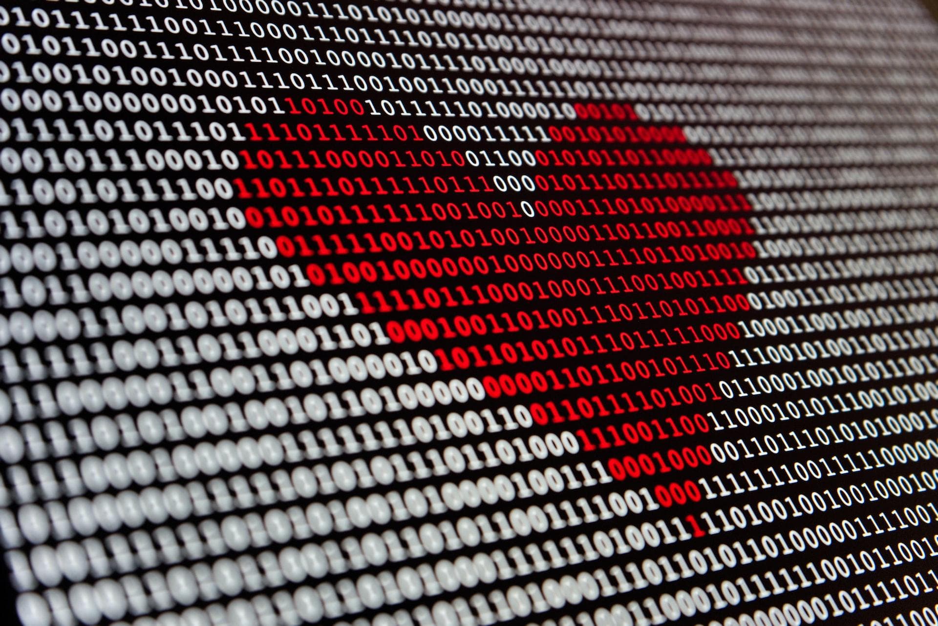 Heart over a screen of 0s and 1s