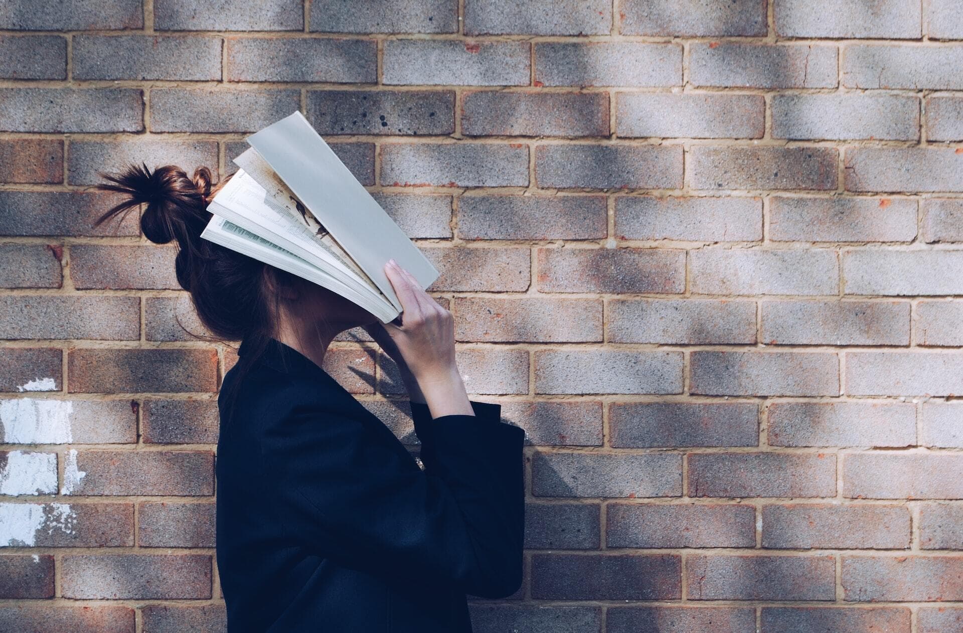Woman with books on her face