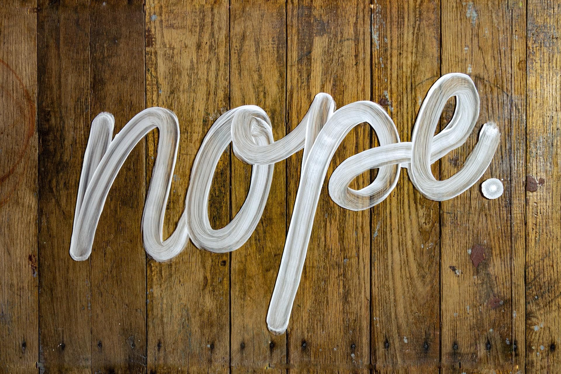 Nope written in paint on wood